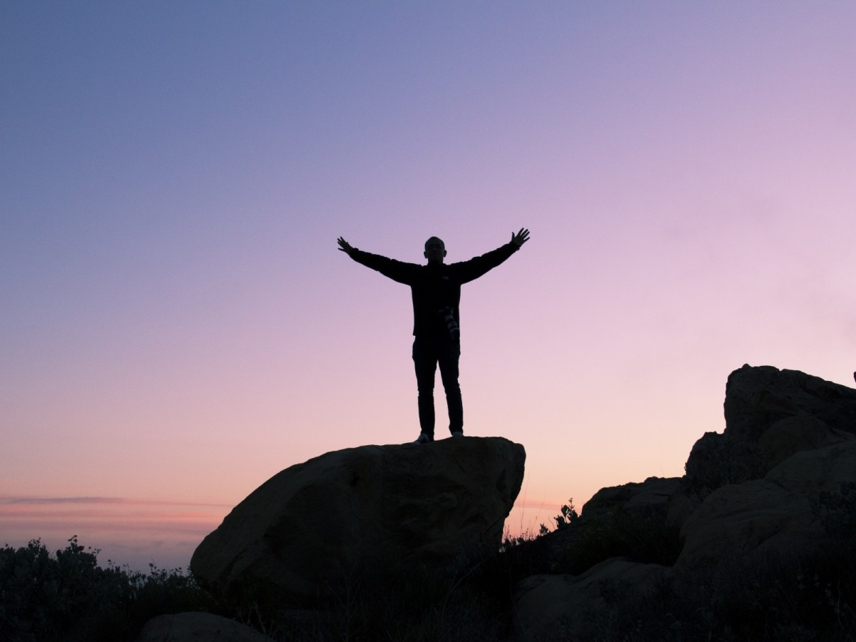 person-silhouette-sunset-rock-boulder-peak